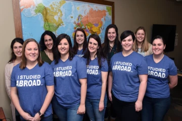 study abroad students pose for a photo wearing a shirt that says "I studied abroad"