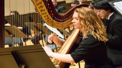 School of Music student playing the harp in the King Concert Hall