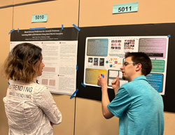 Henry Zelenak (right) discusses his project, “Visualizing Music Preferences: Using Physical Features to Construct Preference Models.”