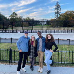 Faculty advisor and students standing in front of the White House