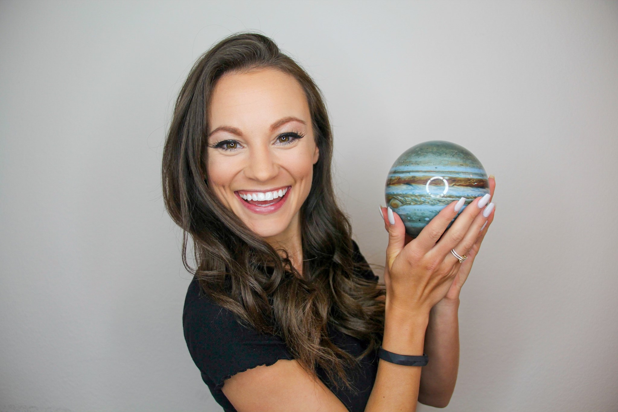 Emily Calandrelli with model of the planet Jupiter