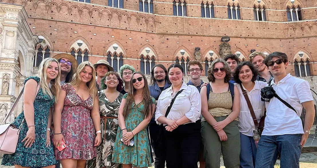 Gathering for a group photo in Siena in the Piazza del Campo are students., Lillian Baer, Isabella Read, Megan Kenny, Alisa Mazon, Gianna Pillitteri, Lilian Holman and Henry Domst; (back row): Angelo Petrilli, James Keller, Jakob Cullen, Ethan Brooks, Devon Kennedy, Andrew Johnson and Benjamin Evans.
