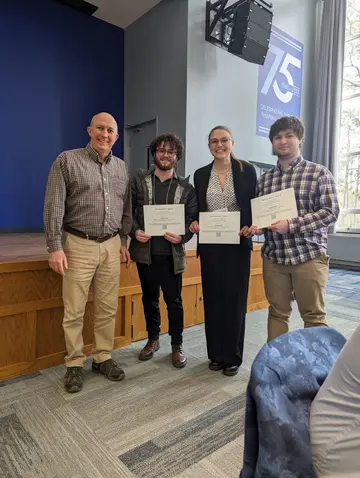 Jay Amicangelo (left), president of the Northwestern Pennsylvania Chapter of Sigma Xi, with SUNY Fredonia students Sawyer Oppenneer, Isabelle Price and Jonas Simora, at the conference awards banquet.