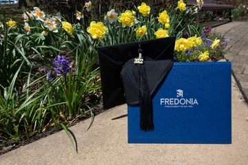photo of diploma holder and mortarboard with tassel with class year