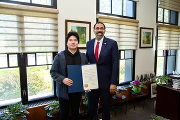 Yan Jiang with SUNY Chancellor John B. King Jr.