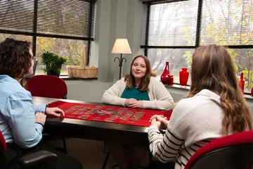 counselor at a table with students