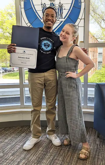 Student of the Month Antonio Reid, with Schulz Hall Residence Director Grace Breen.