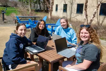 Fredonia students enjoy spring sunshine while studying outside. Consider a major in gender and ethnic studies 